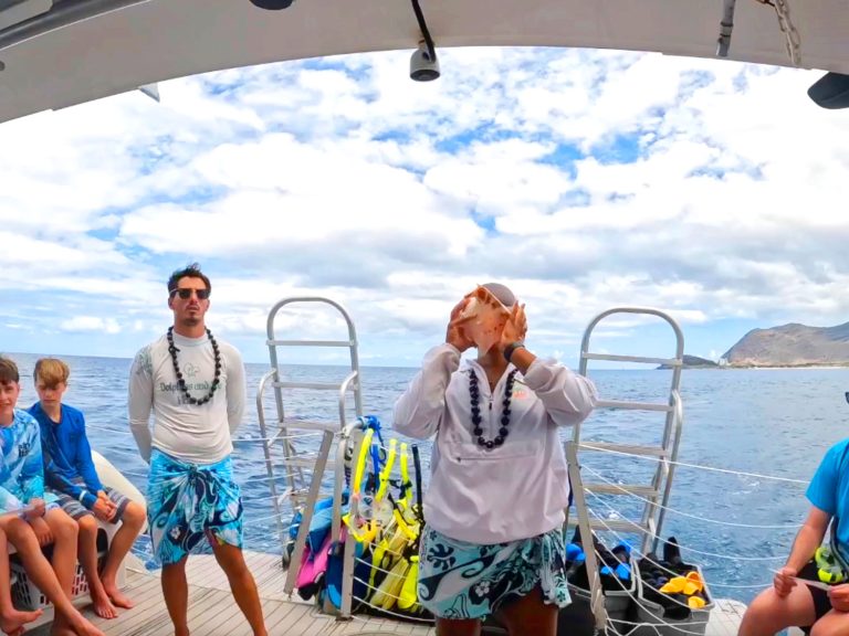 blowing the traditional Hawaiian conch shell