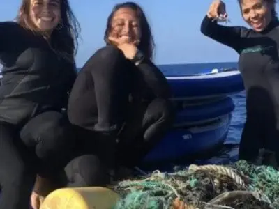 Ladies cleaning the ocean in Oahu